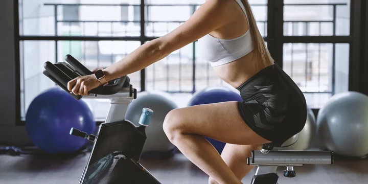 A person working out on an exercise bike at a home gym