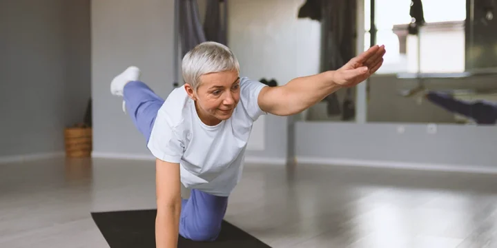 A senior at home doing safe workouts