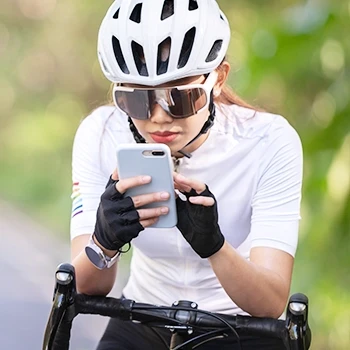 A cyclist connecting her smartphone to her fitness tracker watch
