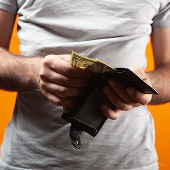 A man checking his wallet to buy 4 Gauge supplement