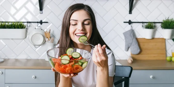 A woman eating a healthy meal to boost her metabolism