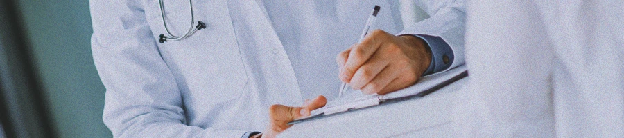 A doctor writing down notes on a clipboard about TRT