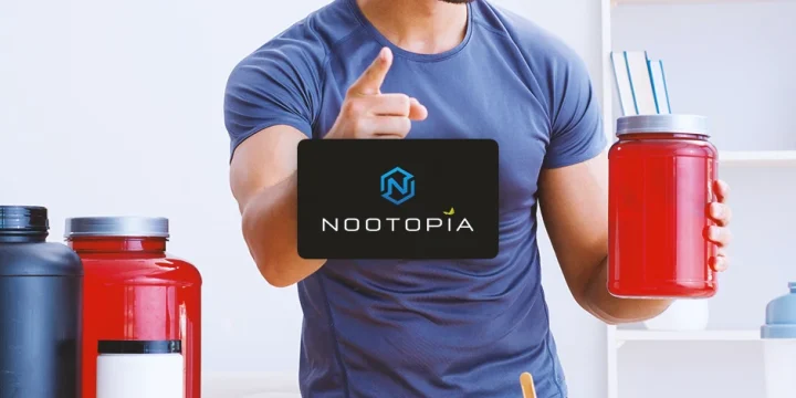 A person holding supplements with nootopia logo in front