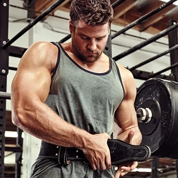 A man wearing a weightlifting belt before doing a workout